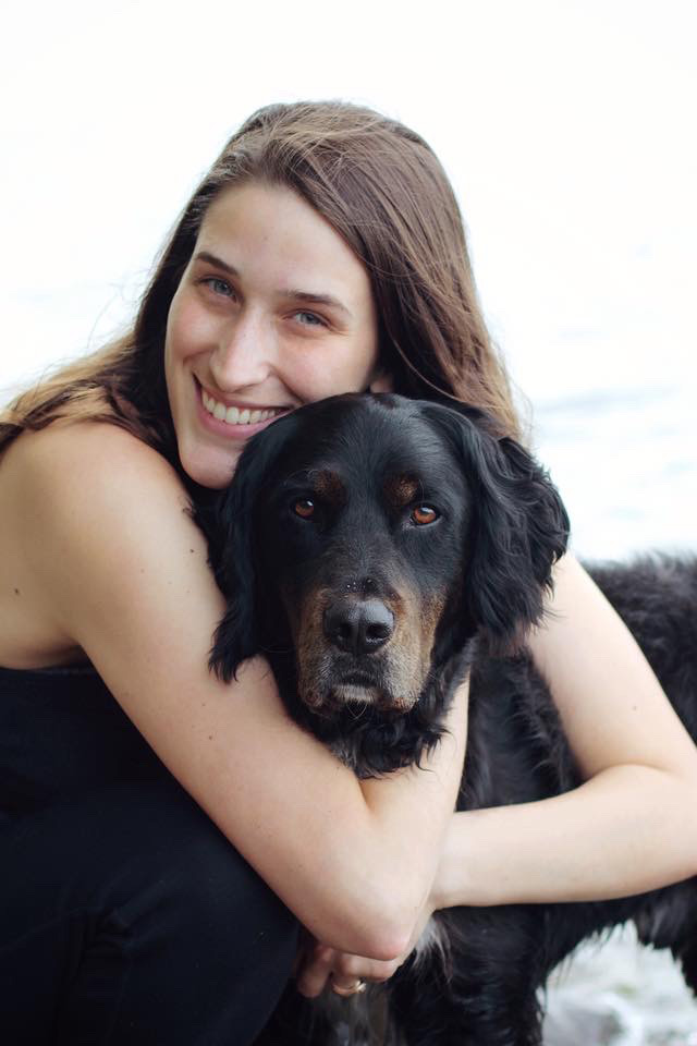 Person and black dog with neutral background