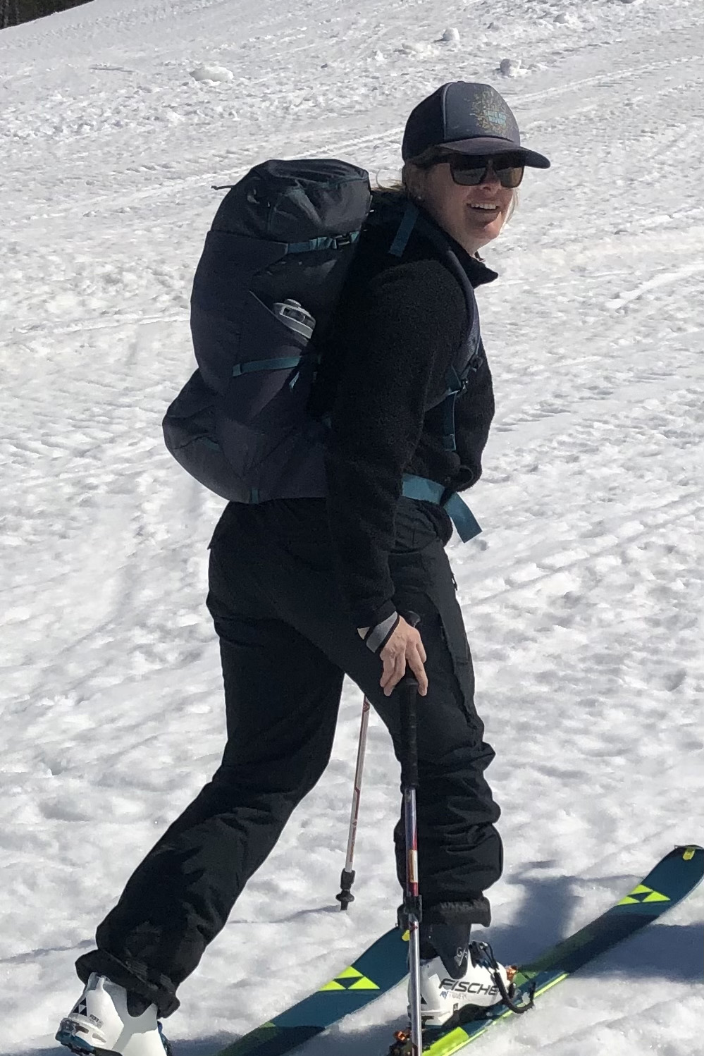 Person in skis with ski poles on snowy hill