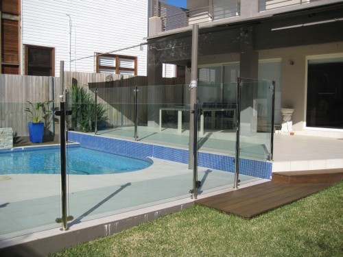 A semi-frameless pool fence using only posts and spigots between glass for a Sydney home.