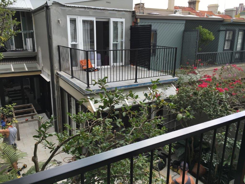 Black aluminium balustrade on the rear balcony of a terrace house