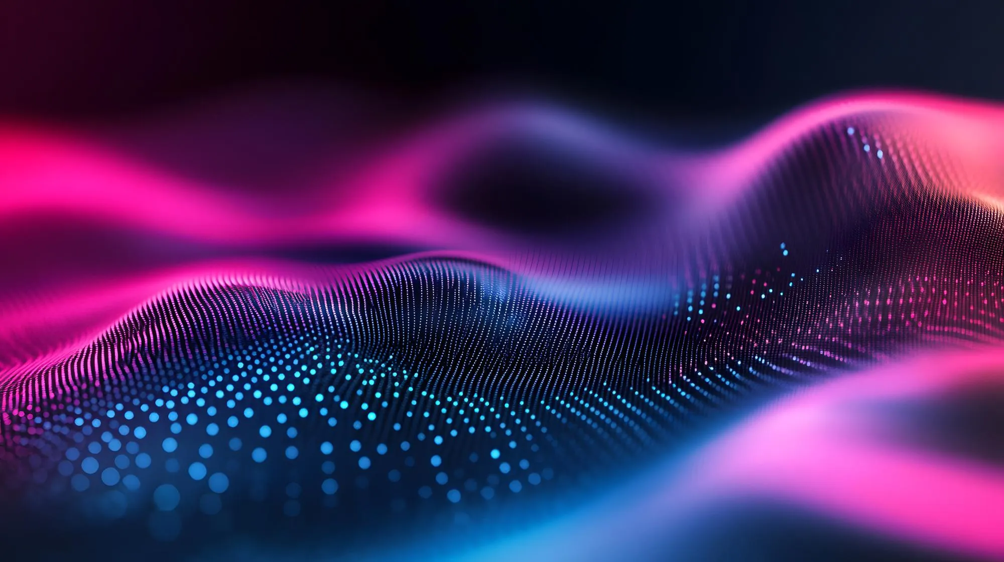 Abstract blue and pink digital wave composed of glowing dots and lines on a dark background.
