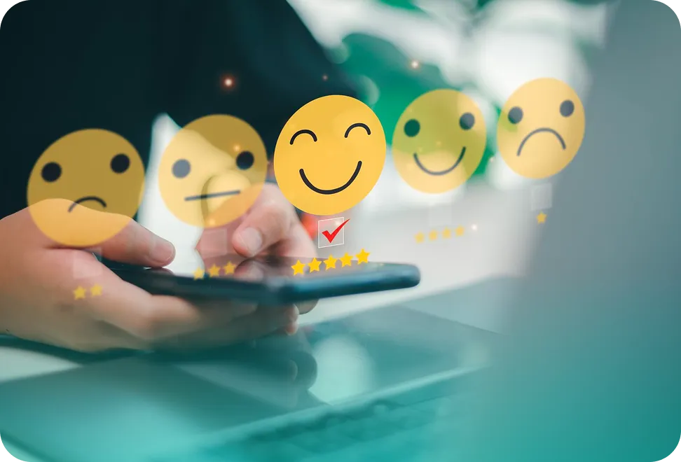 Person holding smartphone with digital customer satisfaction rating icons showing five faces from sad to happy, with the happy face selected.