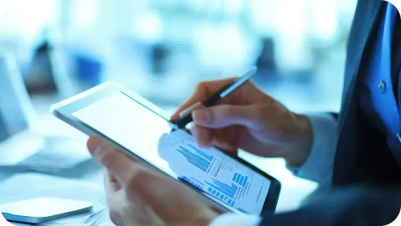 Fintech professional using tablet analytics platform enabled by software modernization