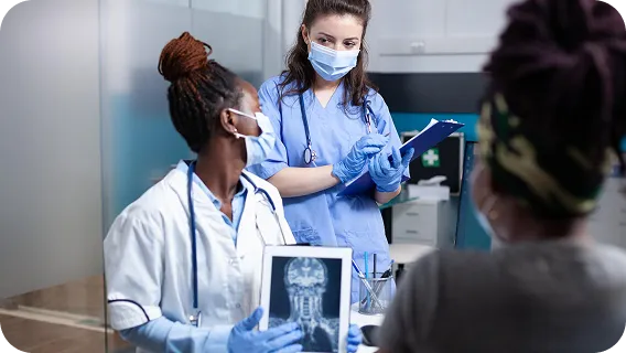 Doctors analyzing X-ray on tablet, representing Healthcare AI MVP solutions