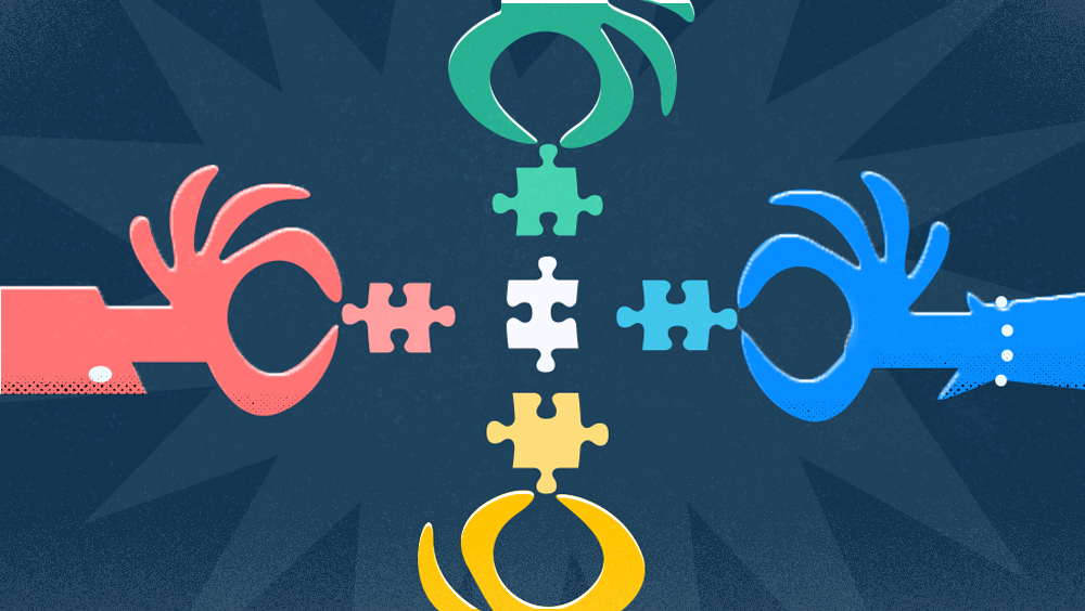 four multi-colored hands holding similarly-colored puzzle pieces.