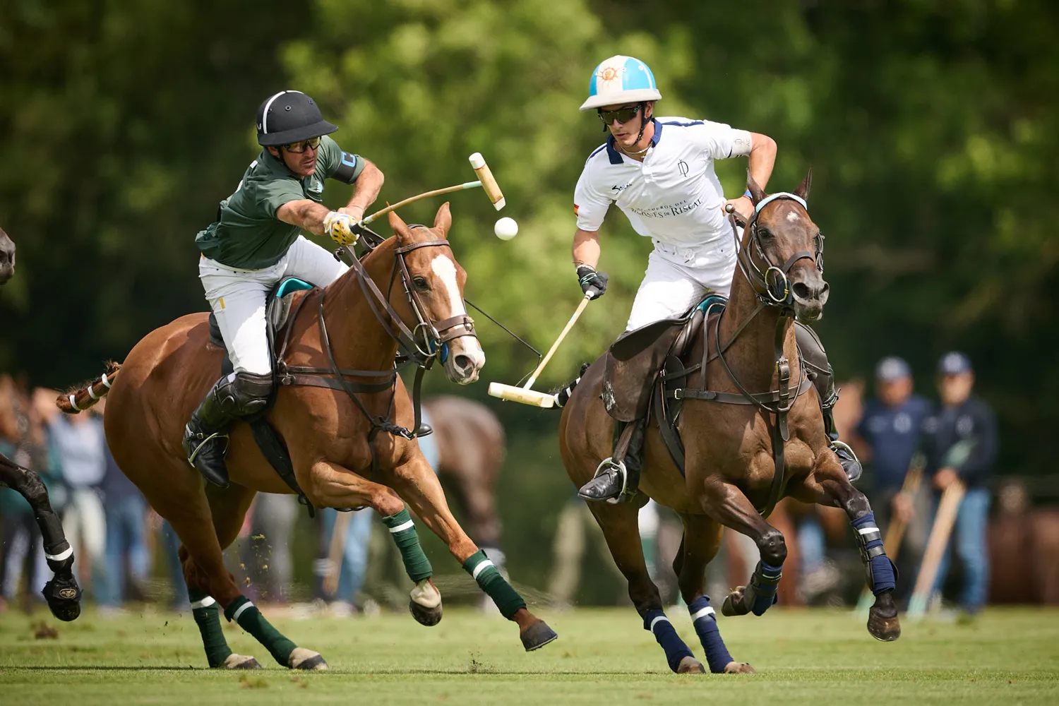 Two polo players challenging for the ball
