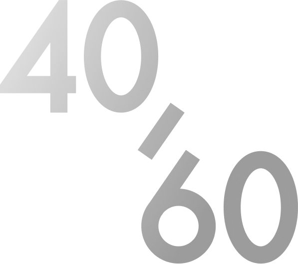 A person with short hair wearing a green sweater looks directly at the camera indoors.