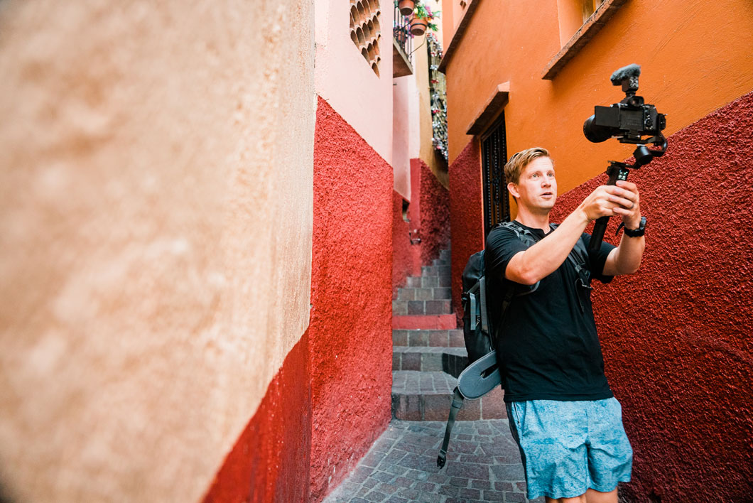 Chris filming in colorful alley