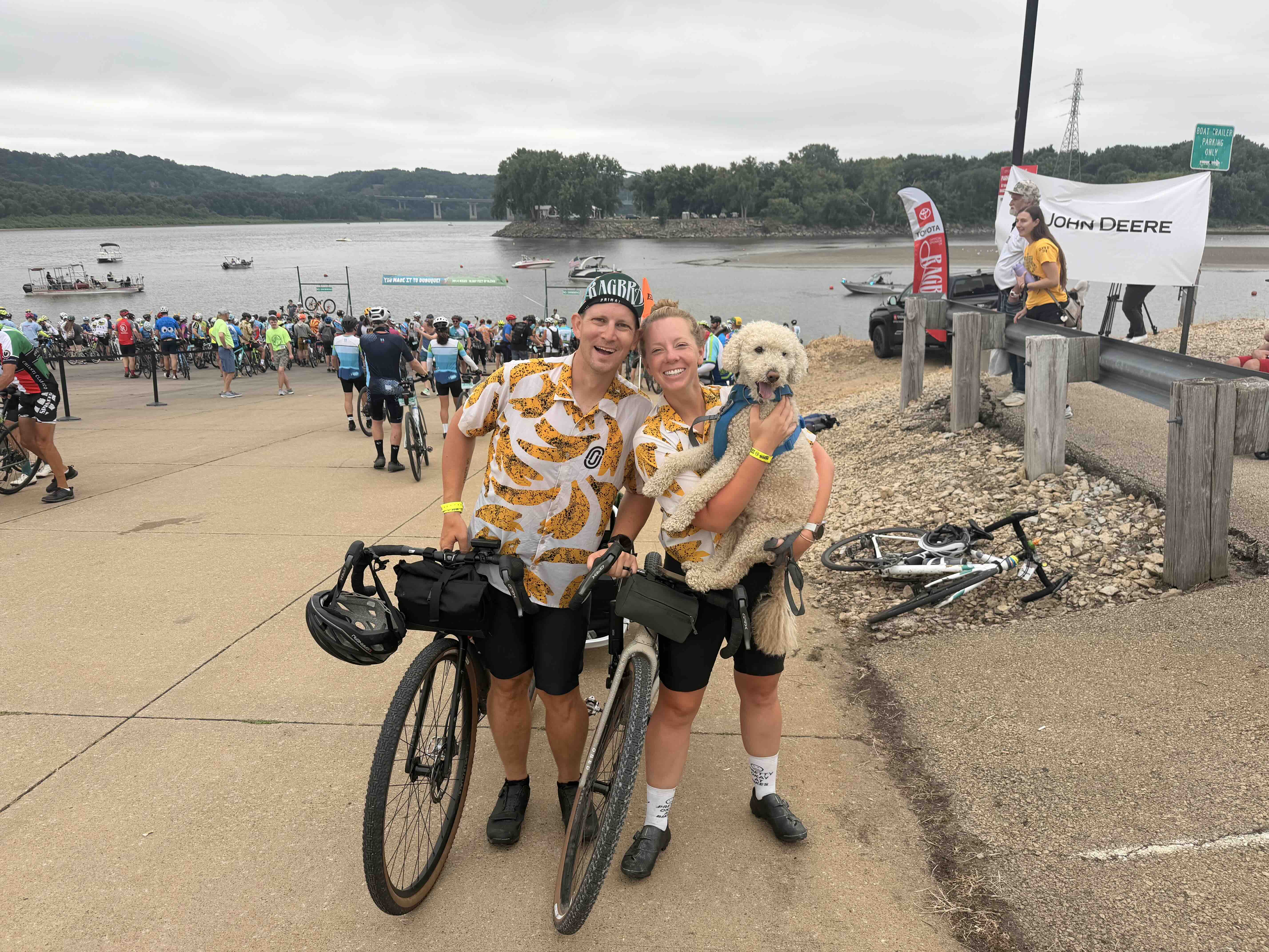 Chris and Sara with their bikes and their dog at the river during RAGBRAI