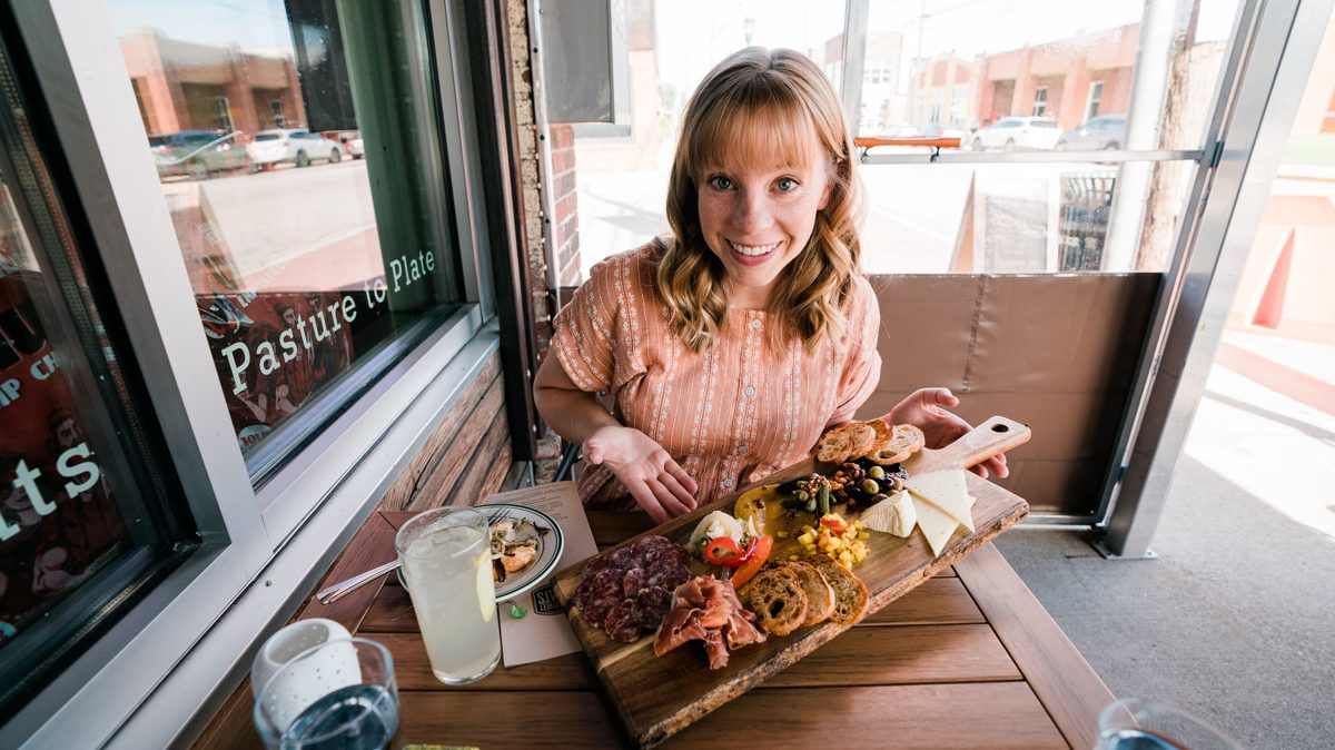 Girl holding up charcuterie at Main Street Meats in Chattanooga, Tennessee