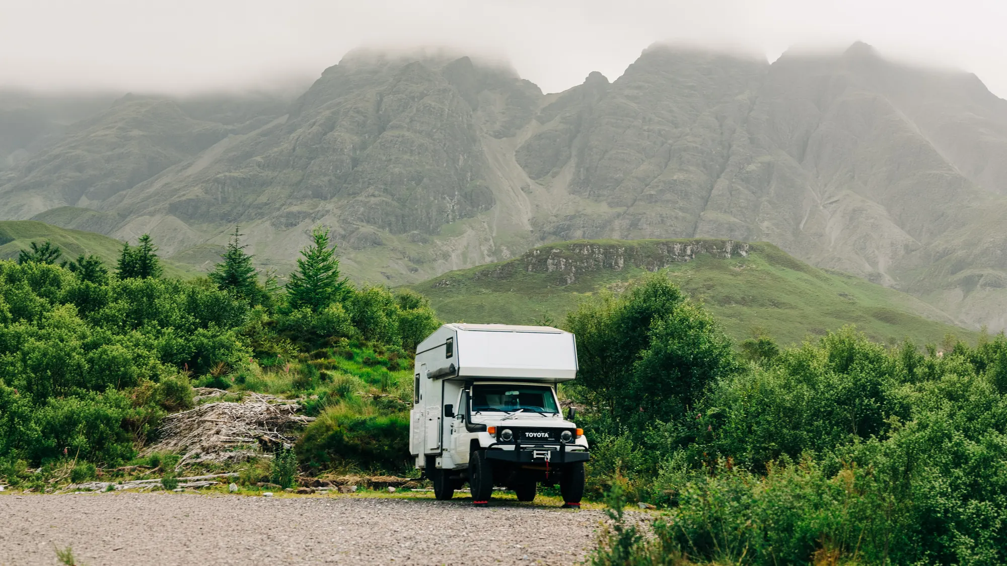 Standing on a cliff edge above the mountains on the NC500, Scotland