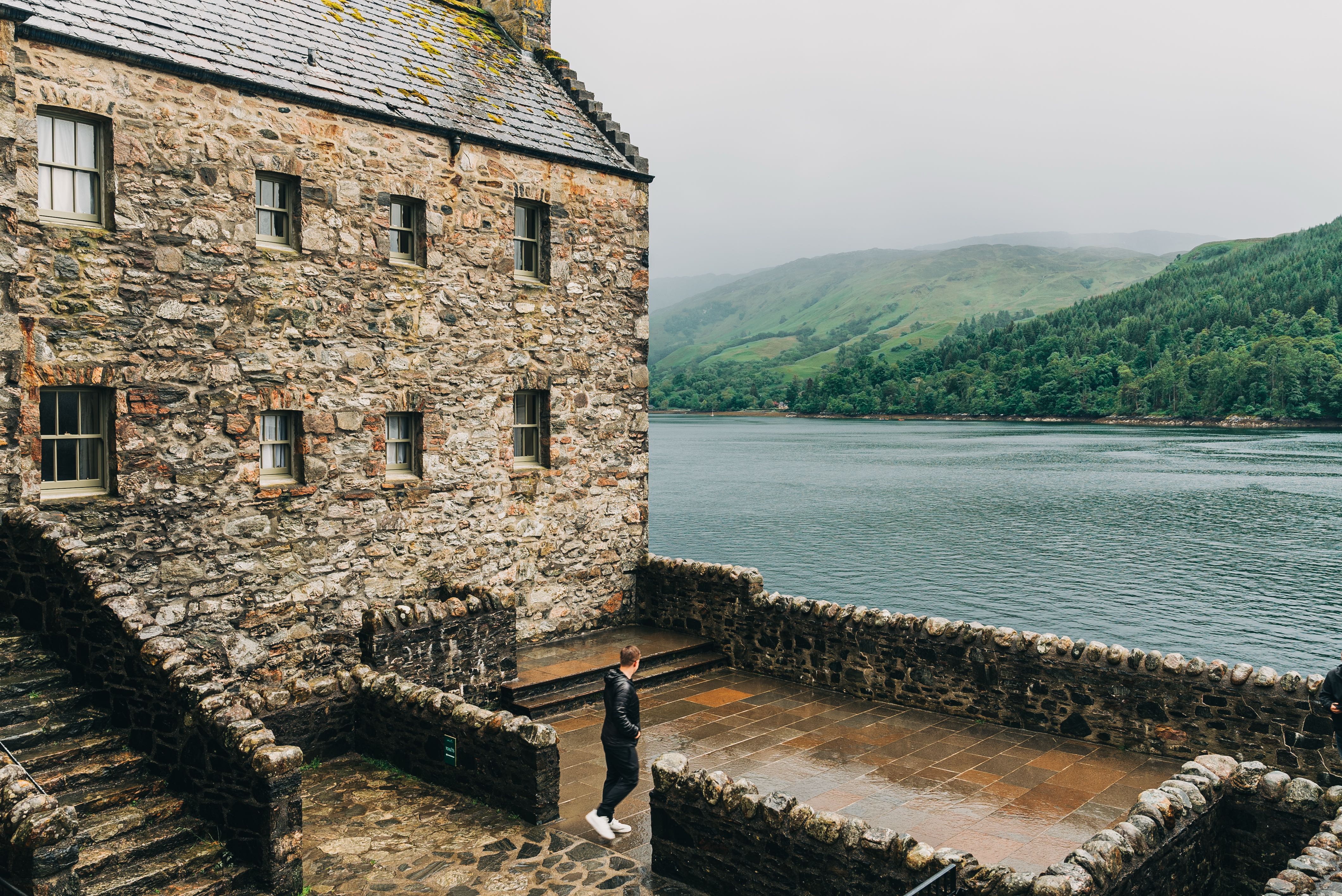 Man walking around Eilean Donan