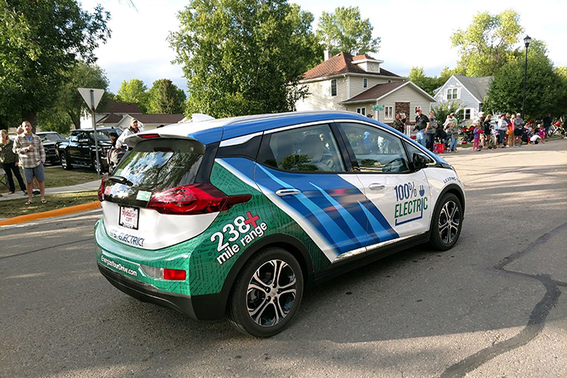The Minnkota Bolt electric vehicle driving on a residential street
