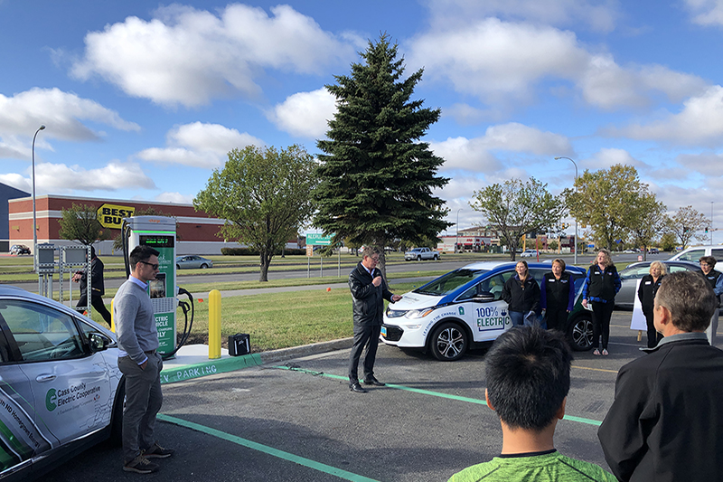 A ribbon cutting event at a new EV fast charging station in Grand Forks, North Dakota.