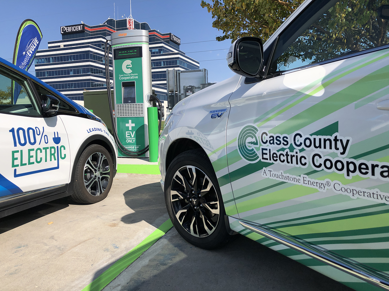 Electric vehicles parked by Cass County Electric Cooperative's new DC fast charging station.