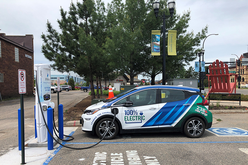 The Minnkota Bolt electric vehicle parked at a charging station in Grand Rapids, Minnesota.