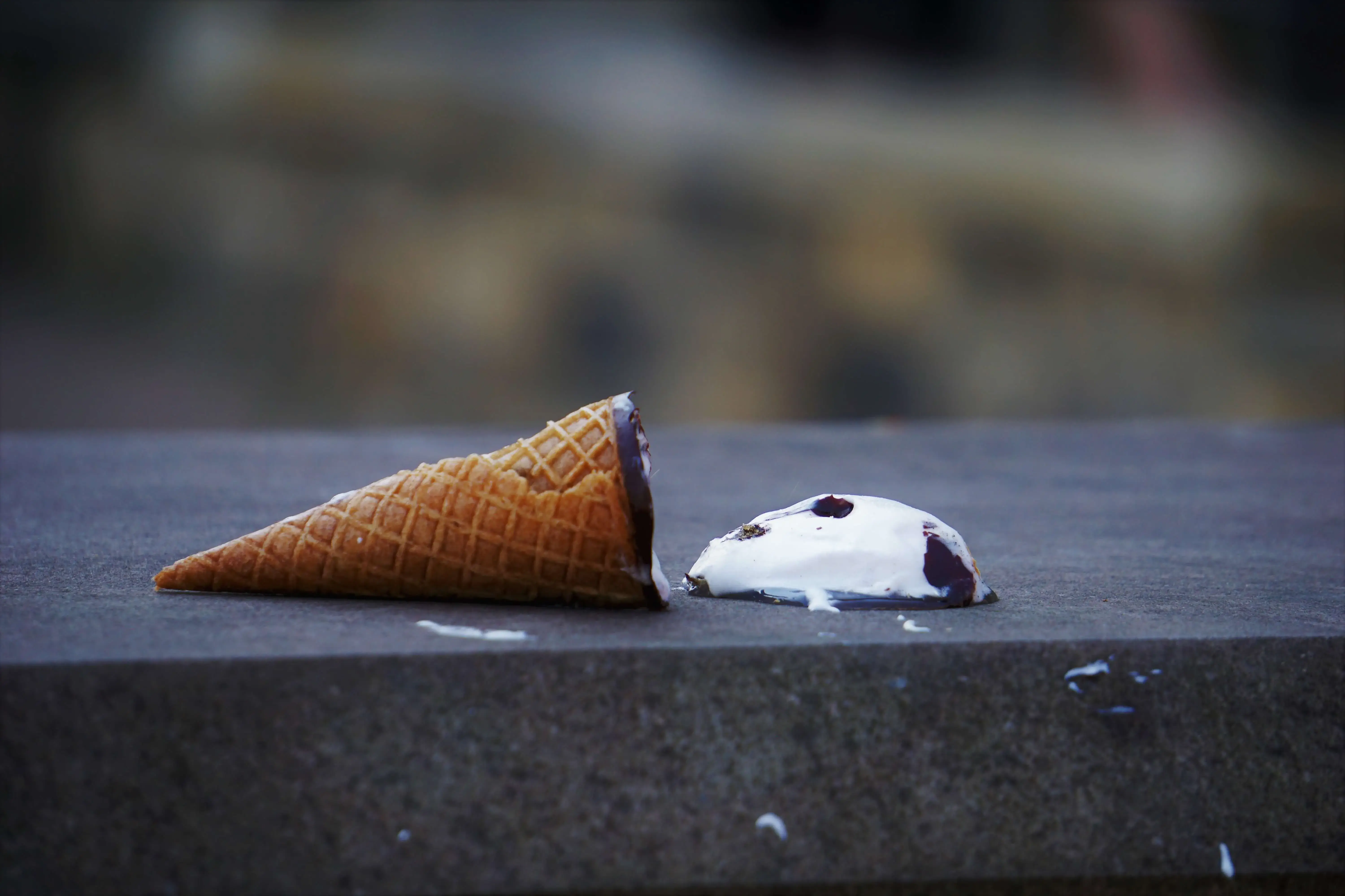 Empty Ice Cream cone with Ice Cream spilled on to the surface