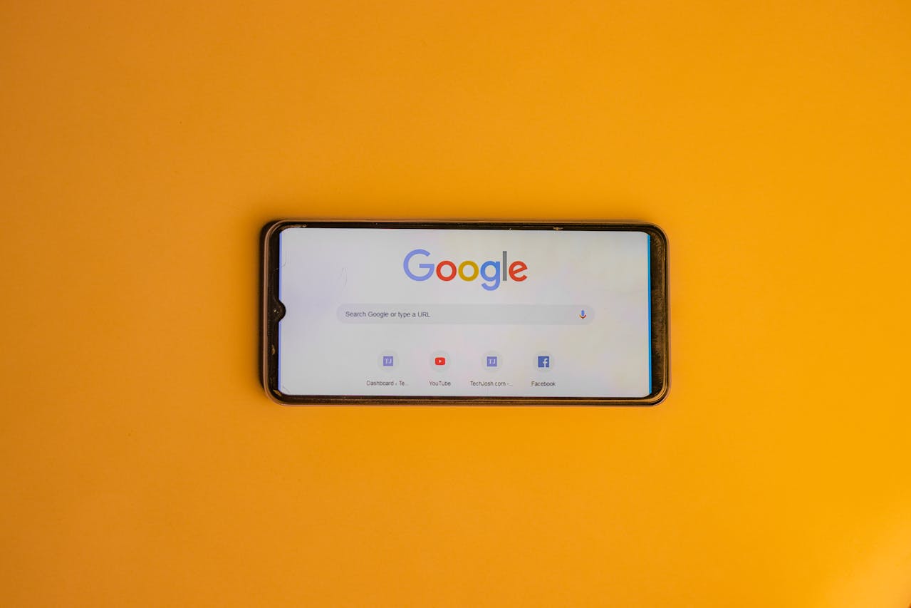 smartphone with Google page opened on yellow background