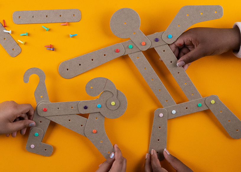 Students celebrating a successful STEM build in a school setting