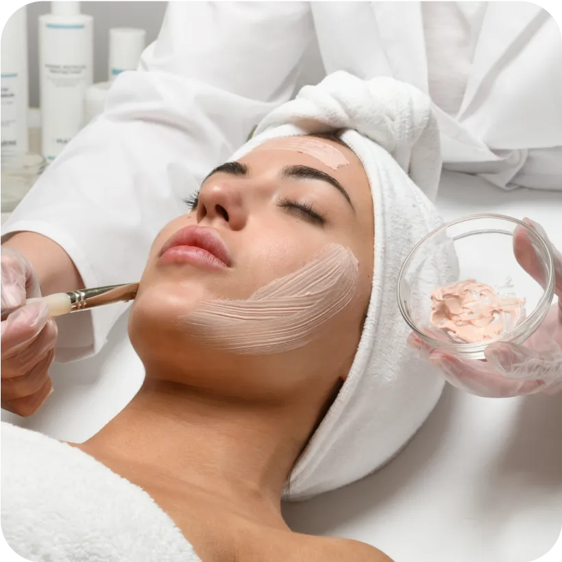 A woman relaxes as Estheticians apply a Jan Marini Facial