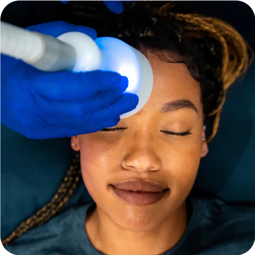 A woman receiving a Neveskin Facial 