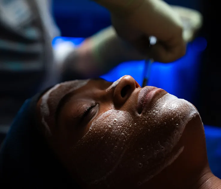 woman receiving a chemical peel from her local Restore Hyper Wellness