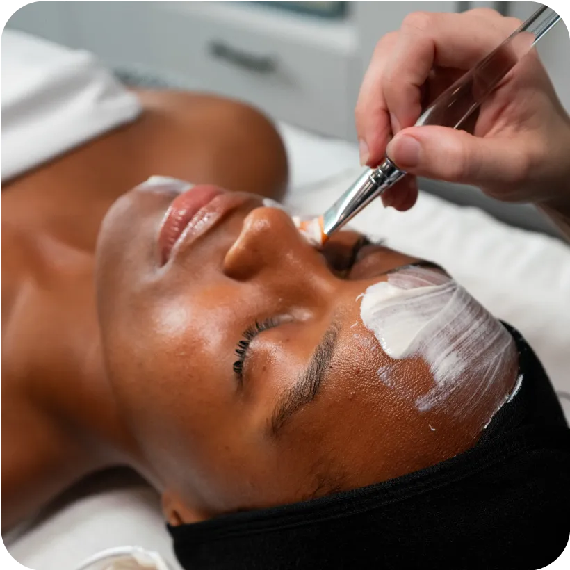 A woman relaxing and enjoying her Retinol + Glycolic Resurfacing Peel from her nearby Restore location
