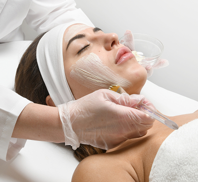 Brunette woman receiving a mild chemical peel from her local Restore