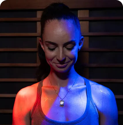 woman in athletic gear relaxing in infrared sauna