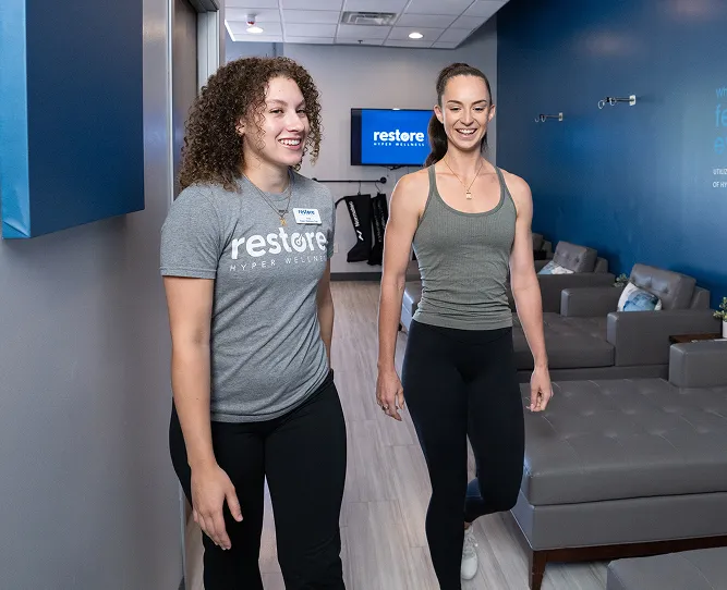 A Restore employee giving a studio tour