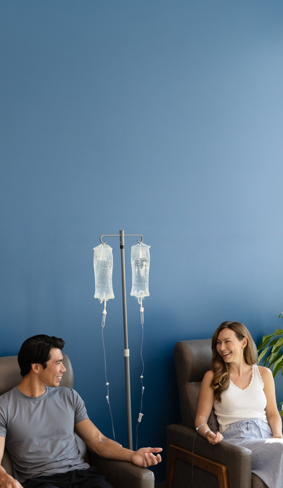 Two members receiving IV drips in a Restore studio