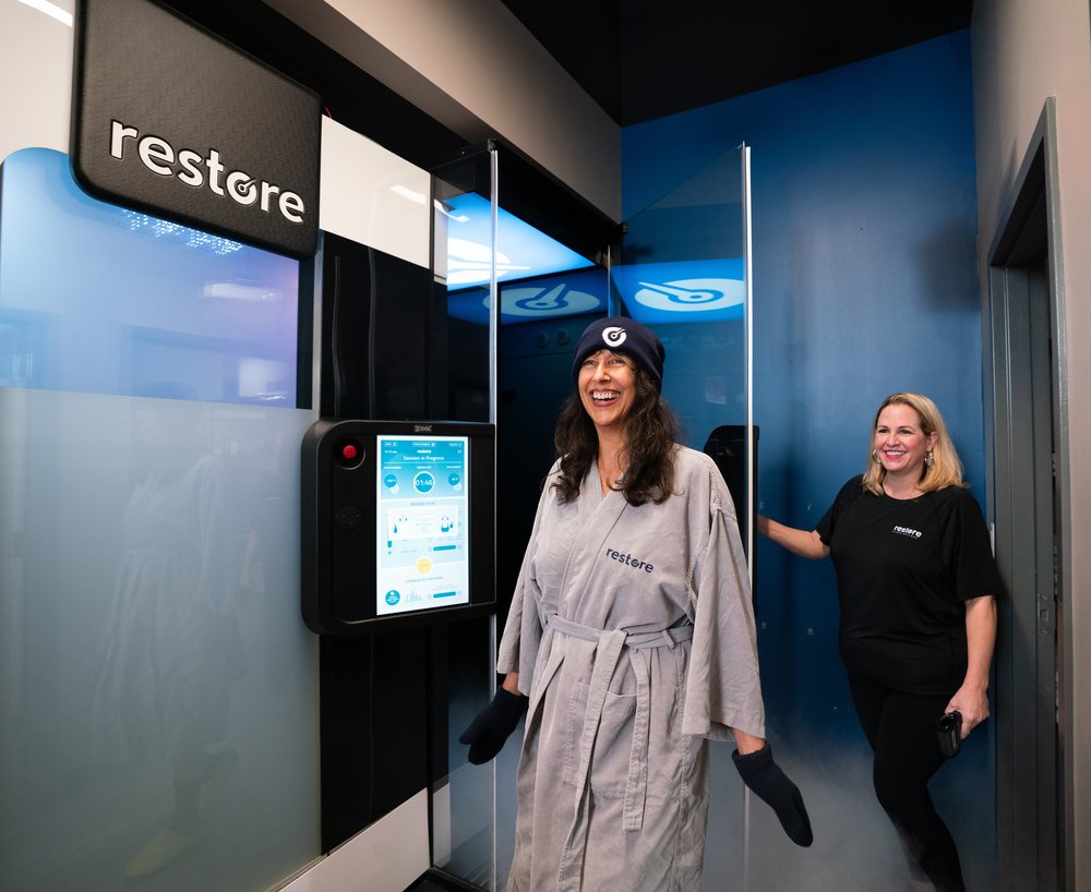Team member assisting a client with a cryotherapy session