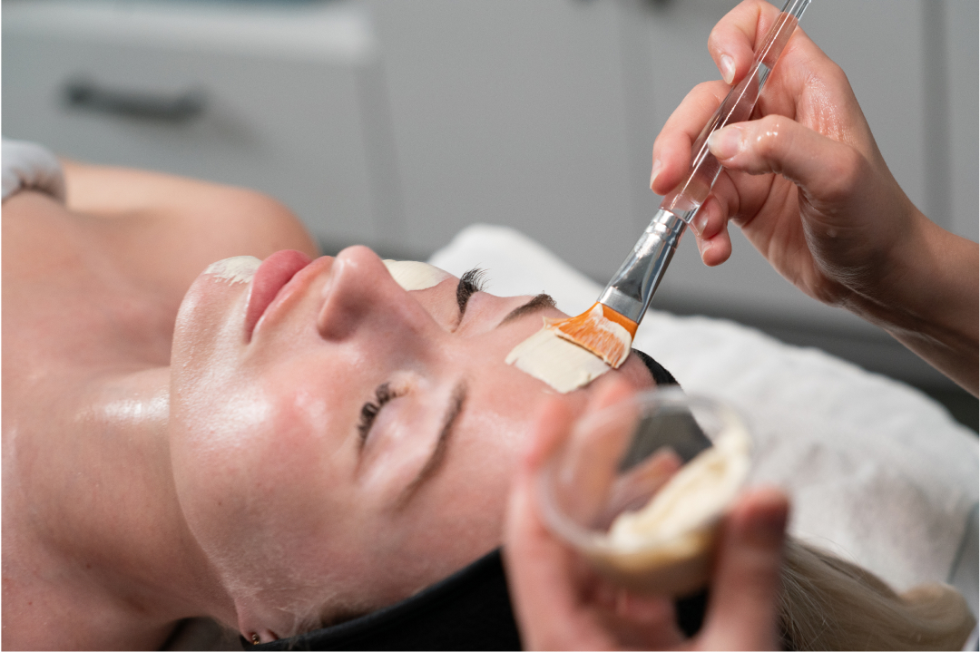 Esthetician applying a facial peel