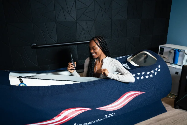 Client inside a Mild Hyperbaric Oxygen Therapy chamber