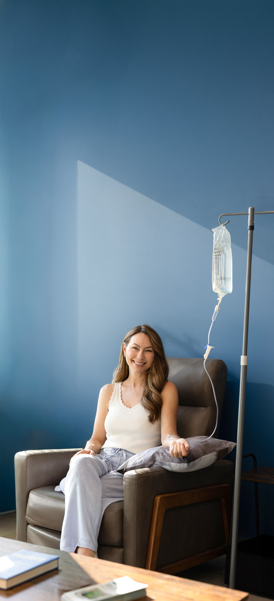 Woman relaxing in an IV Drip lounge chair at Restore