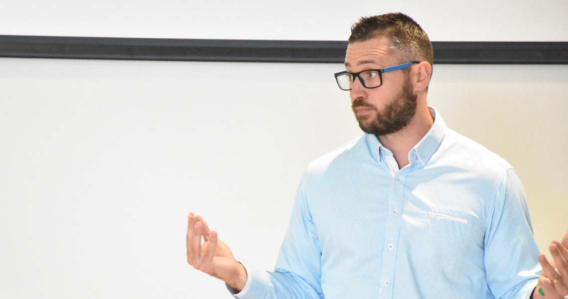 An image of business people sitting behind a table