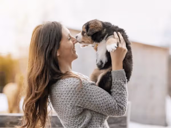 A woman holding a puppy, representing the experience of adopting a puppy from a puppy rescue in Chicago