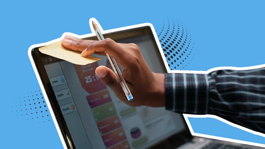 Hand placing a sticky note on a laptop screen displaying analytics, symbolizing quick website optimization and attention-grabbing strategies.