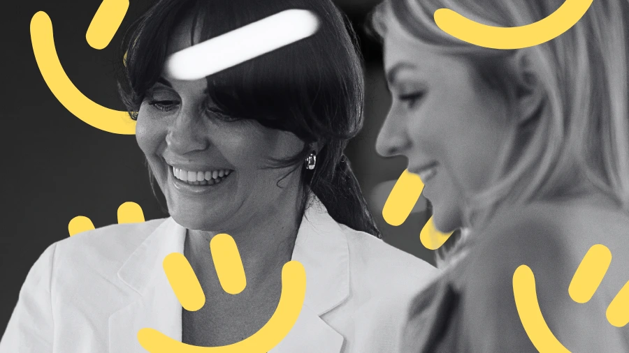 Two smiling women collaborating, symbolizing trust and connection—key psychological triggers that influence client decisions.