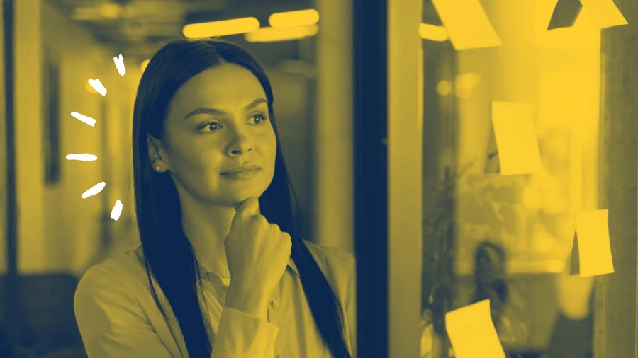 Woman looking at ideas on a sticky note and brain storming