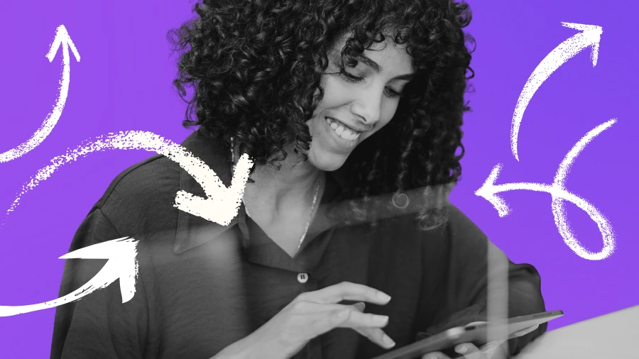 Smiling marketer using a tablet with arrows illustrating an automated marketing ecosystem that works while you’re offline