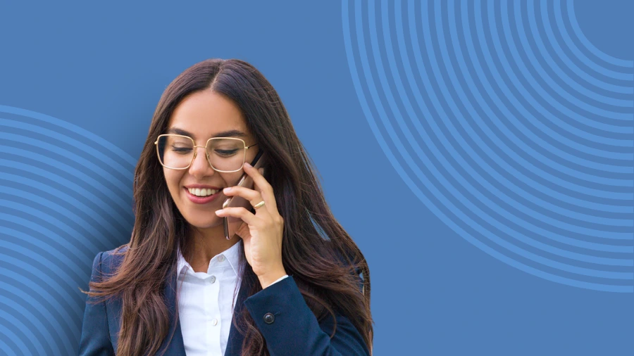 Smiling professional woman on a phone call, symbolizing productive communication and scaling a business efficiently