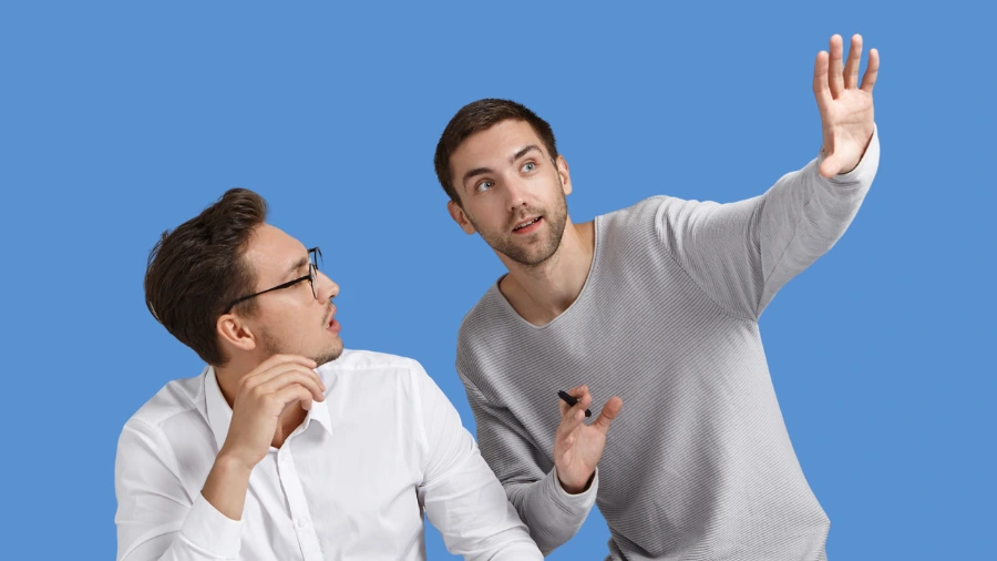 Two business professionals discussing ideas, symbolizing communication, overexplaining services, and simplifying messaging for better sales conversions