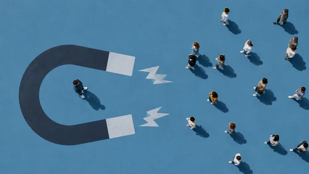 Minimal aerial-view thumbnail showing a large magnet attracting scattered people across a blue surface, symbolizing marketing that gains attention but may not attract the right buyers.