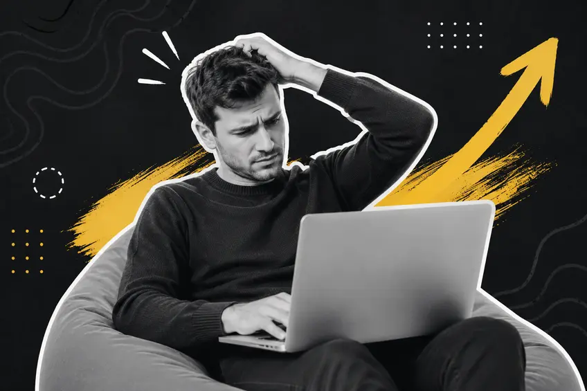 Confused entrepreneur working on a laptop against a bold graphic background, symbolizing the challenges of managing unnecessary business complexity.
