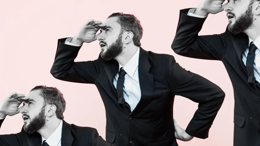 Three businesspeople in suits looking into the distance with hands raised to their foreheads, symbolizing searching for answers or direction.