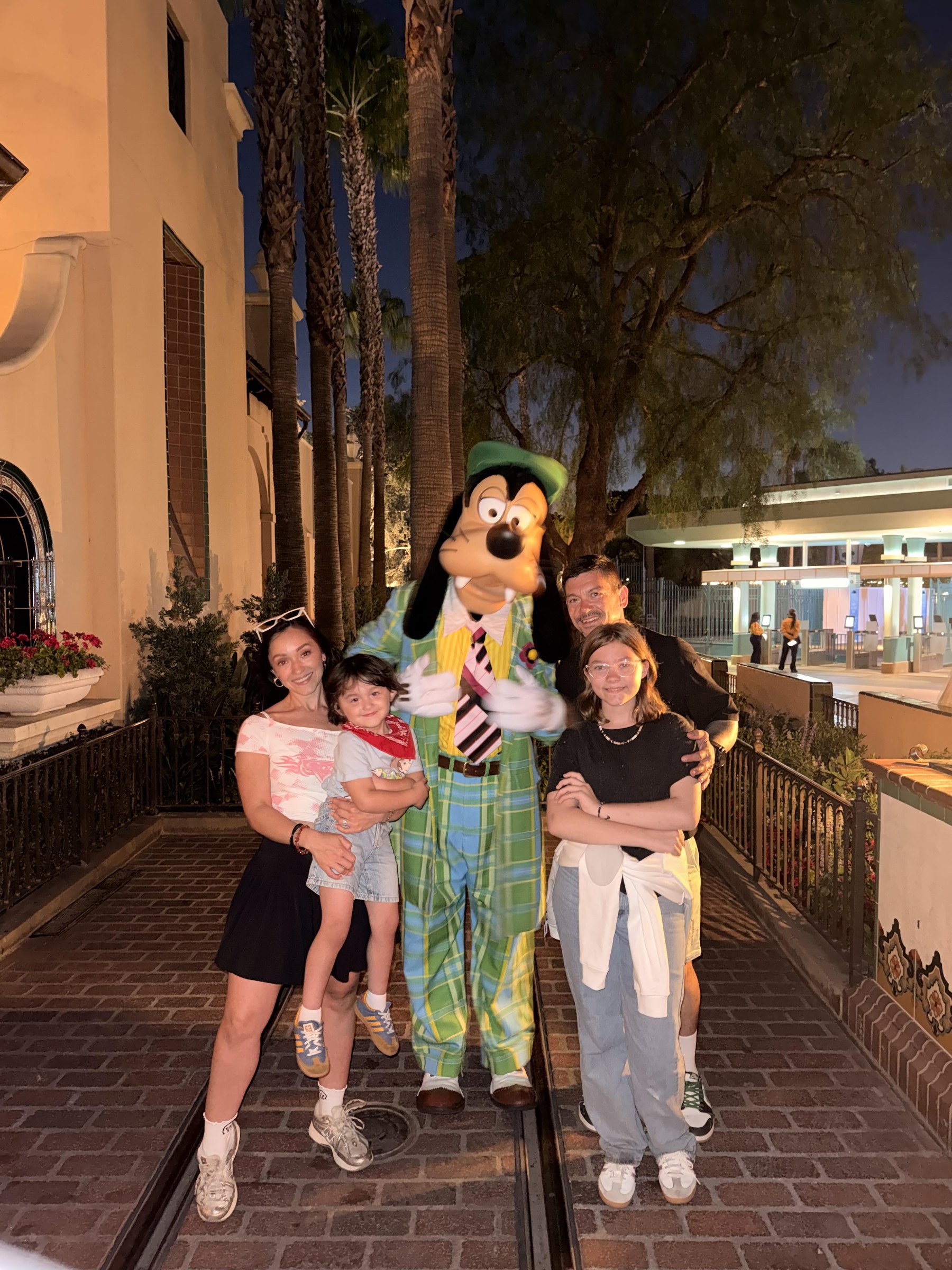 Layn Chess and family with a character at night