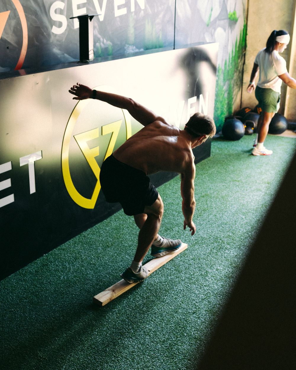 Member working on balance on the turf
