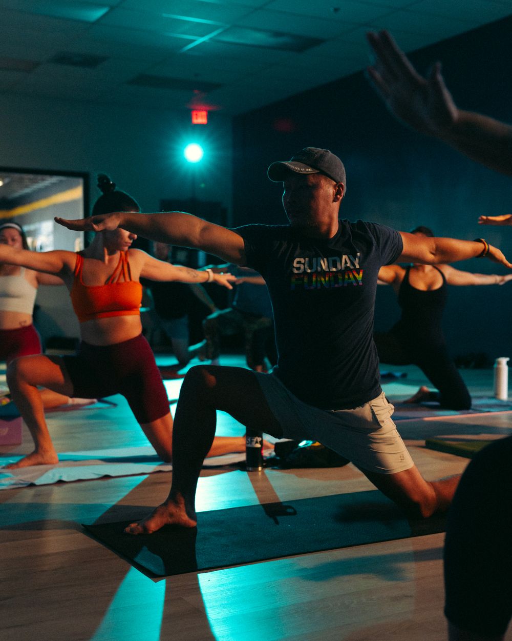 Members moving through a coached yoga class