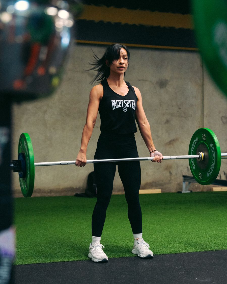 Member deadlifting on the turf